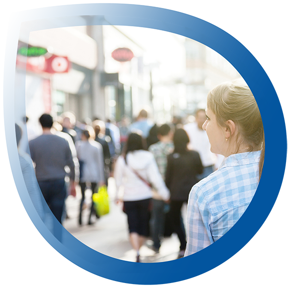 Woman walking down busy retail street